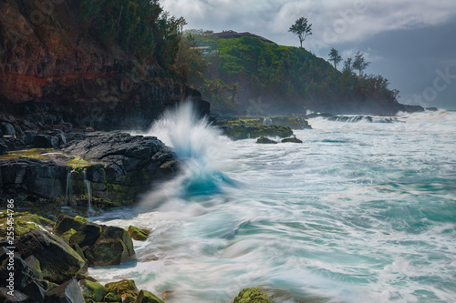 Waves crashing against rocks in Hawaii