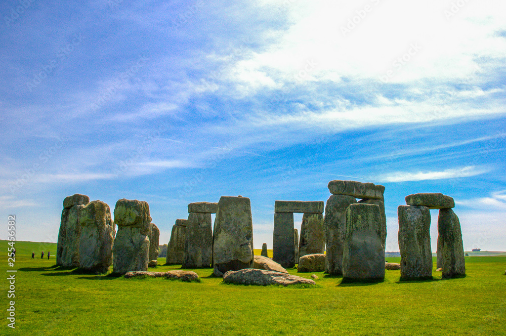 Naklejka premium Travel England, United Kingdom. Popular tourist destination in Europe. The ancient monument, famous, mysterious Stonehenge attraction. Sunny day, blue sky. Travel/outdoor background.