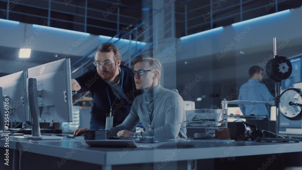 Electronics Development Engineer Uses Personal Computer Talks with Manager, Shows Project. Team of Professionals Use Digital Whiteboard use CAD Software for the Modern Industrial Engineering Design