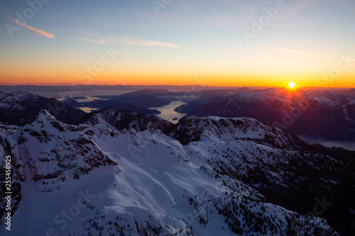 Aerial view of Canadian Mountain Landscape during a vibrant sunset. Taken near Squamish  North of Vancouver  British Columbia  Canada.