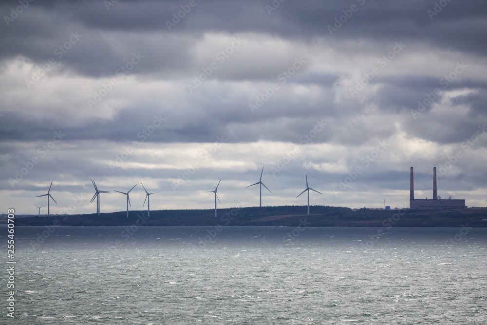 Wind Turbine on the ocean coast during a cloudy day. Taken in New Victoria, Nova Scotia, Canada.