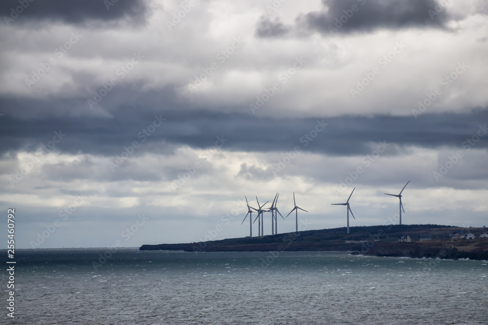 Wind Turbine on the ocean coast during a cloudy day. Taken in New Victoria, Nova Scotia, Canada. Wind Turbine on the ocean coast during a cloudy day. Taken in New Victoria, Nova Scotia, Canada.
