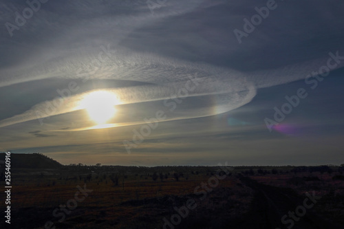 Condensation traces from the aircraft. Dramatic sky at sunset. Selective focus  place for text.