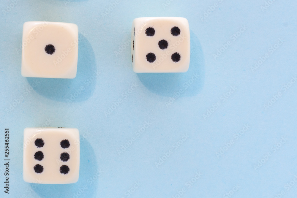 White gaming dices on light blue background. victory chance, lucky. Flat lay, place for text. Top view. Close-up. Concept gamble. spectacular pastel White gaming dices on light blue background. victory chance, lucky. Flat lay, place for text. Top view. Close-up. Concept gamble. spectacular pastel