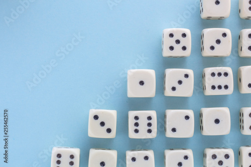 White gaming dices on light blue background. victory chance  lucky. Flat lay  place for text. Top view. Close-up. Concept gamble. spectacular pastel