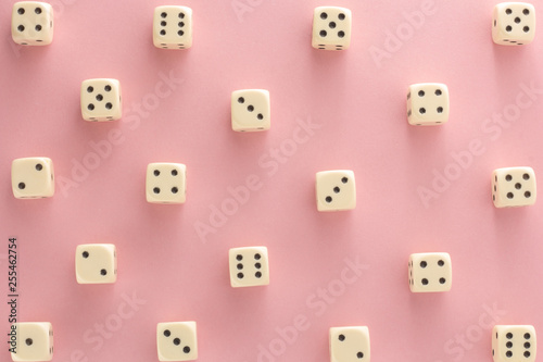 White gaming dices on pink background. victory chance  lucky. Flat lay  place for text. Top view. Close-up. Concept gamble. spectacular pastel