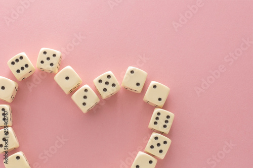 White gaming dices on pink background. victory chance  lucky. Flat lay  place for text. Top view. Close-up. Concept gamble. spectacular pastel