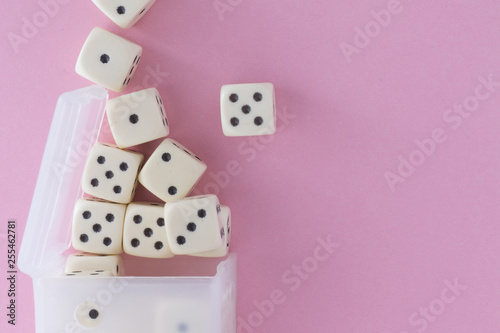White gaming dices on violet background. victory chance  lucky. Flat lay  place for text. Top view. Close-up. Concept gamble. spectacular pastel