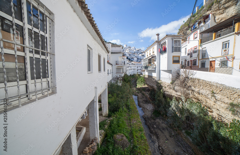 Street with dwellings built into rock overhangs. Setenil de las Bodegas, Cadiz, Spain