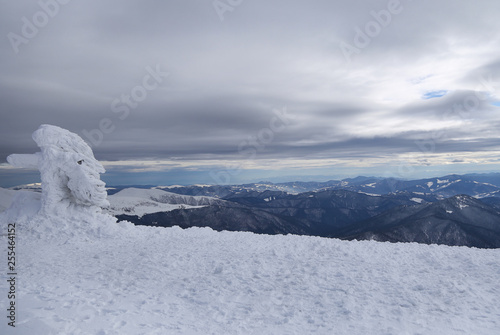 Winter landscape with mountains and clouds