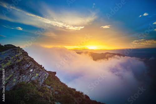 Above the clouds mountain sunset landscape in Romania