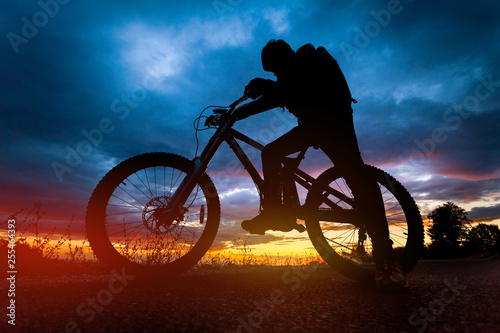 Fototapeta Naklejka Na Ścianę i Meble -  Mountain bike rider silhouette at sunset
