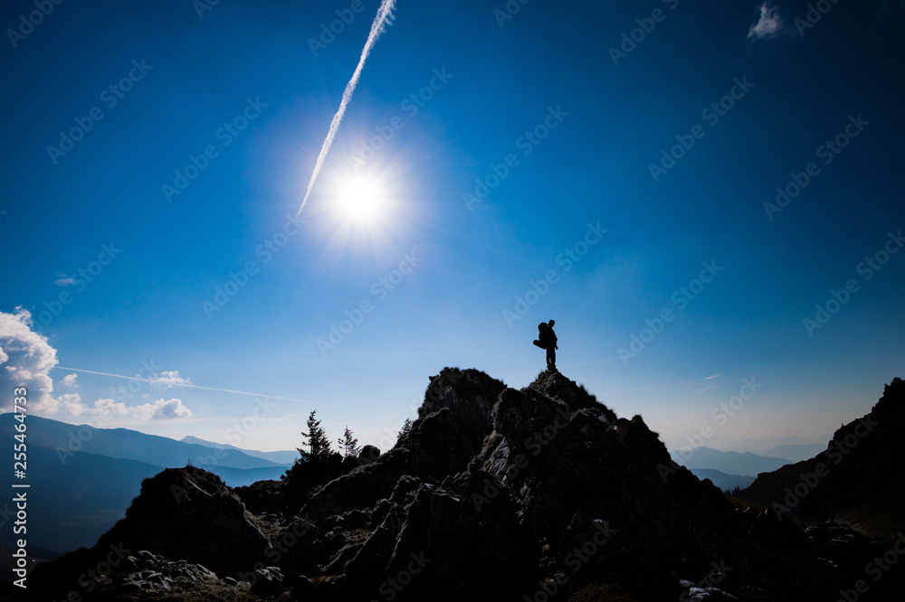Adventure, achievement success concept photo hiker on top of the mountain