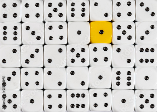 Background of random ordered white dices with one yellow cube