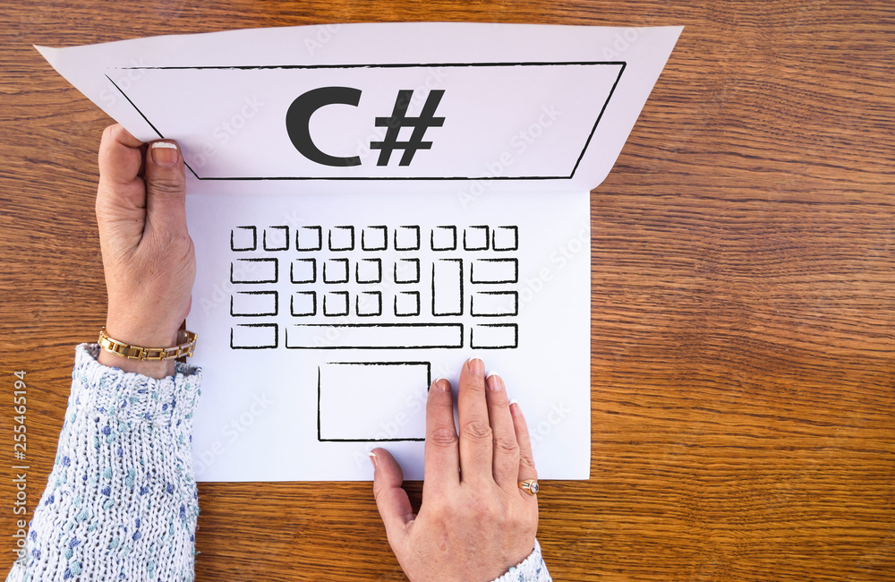 C# . woman hands and laptop drawn on paper sheet and c sharp programing ...