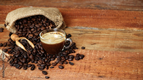 Coffee cup with Coffee beans, burlap sack and with cinnamon sticks