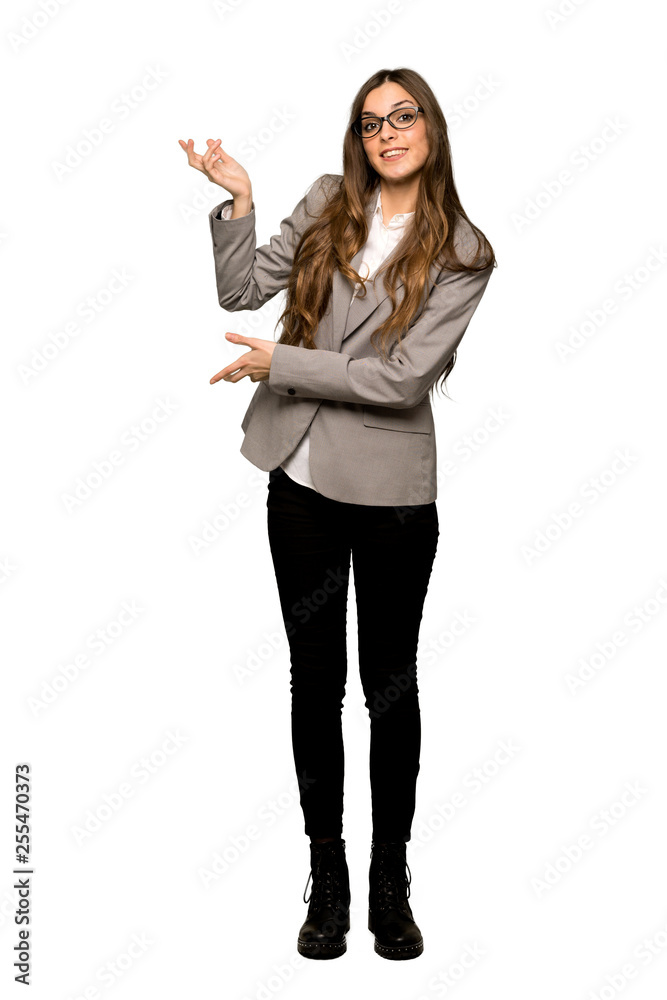 Full-length shot of Business woman extending hands to the side for inviting to come on isolated white background Full-length shot of Business woman extending hands to the side for inviting to come on isolated white background