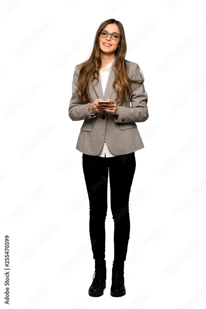 Full-length shot of Business woman sending a message with the mobile on isolated white background Full-length shot of Business woman sending a message with the mobile on isolated white background