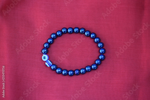 White gold diamond ring on top of colored stones. Romantic background ( Valentine's Day) 