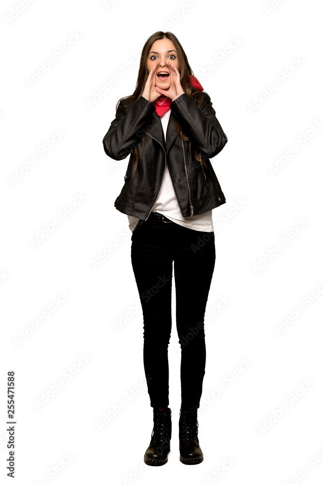 Full-length shot of Young woman with leather jacket shouting and announcing something on isolated white background Full-length shot of Young woman with leather jacket shouting and announcing something on isolated white background