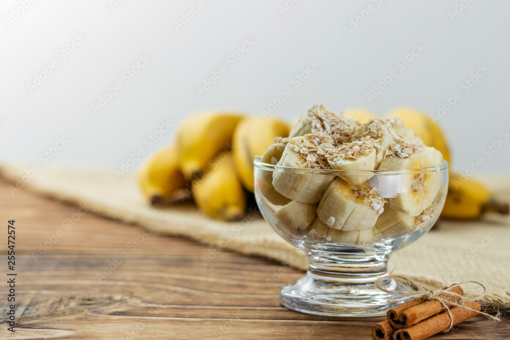 Fototapeta premium close up on glass jar with pieces of banana with oats