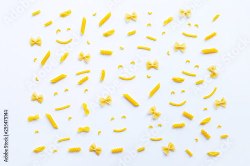 Different types of dry pasta on white.