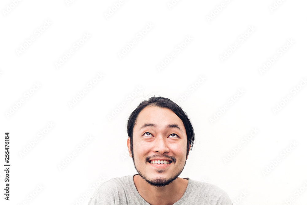 Portrait of happy smiling asian young handsome man looking up at empty copy space isolated on white background Portrait of happy smiling asian young handsome man looking up at empty copy space isolated on white background