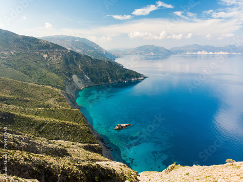 Scenic aerial view of picturesque jagged coastline of Kefalonia with clear turquoise waters  surrounded by steep cliffs.
