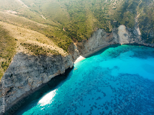 Scenic aerial view of picturesque jagged coastline of Kefalonia with clear turquoise waters, surrounded by steep cliffs.