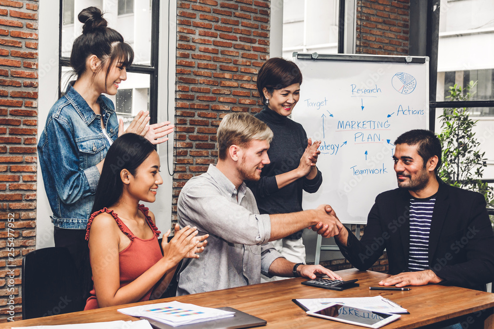 Success of handshake business partners and group of casual business clapping hands in the meeting.Partnership approval and thanks gesture concept Success of handshake business partners and group of casual business clapping hands in the meeting.Partnership approval and thanks gesture concept