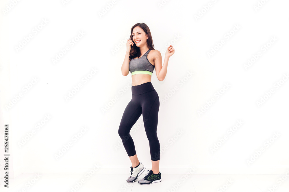 Sport woman in sportswear relax stand after workout against copy space for adding text with white wall background.Diet concept.Fitness and healthy lifestyle
