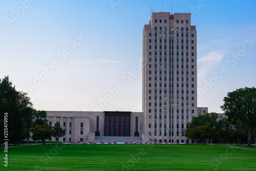 North Dakota state Capitol building in the afternoon with lights on