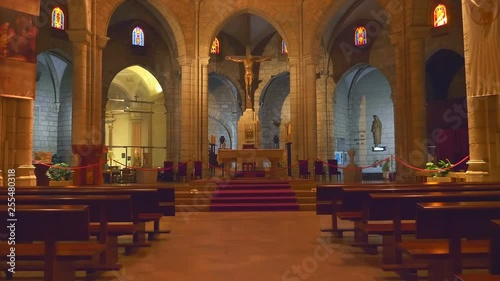 In the Spain inside the ancient church affects the design and richness of decoration and  antique national artifacts - icons, statues of Saints, pictures and art paintings. Shot in motion photo