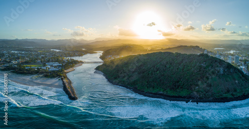 Aerial landscape of Tallebudgera river mouth and Burleigh Head National Park at sunset. Gold Coast, Queensland, Australia