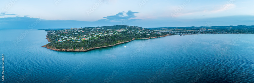 Aerial panorama of luxury real estate of Mount Martha suburb coastline at dusk with copy space