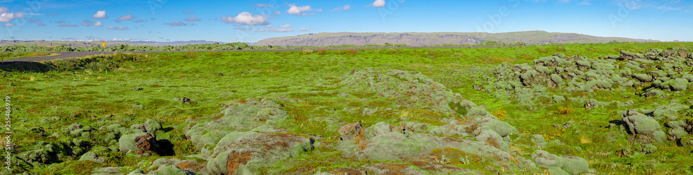 The Beautiful panorama view of blue sky and eldhraun lava field. The Green moss covered lava rock. The Beautiful panorama view of blue sky and eldhraun lava field. The Green moss covered lava rock.