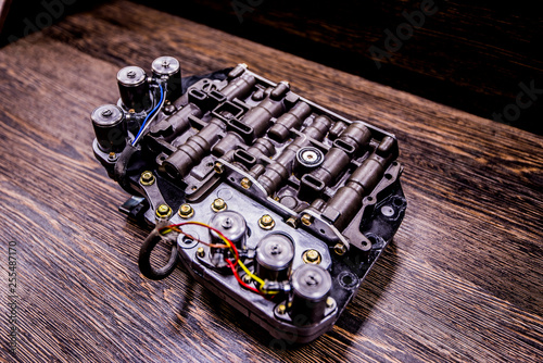 Automatic transmission valve body on wooden background