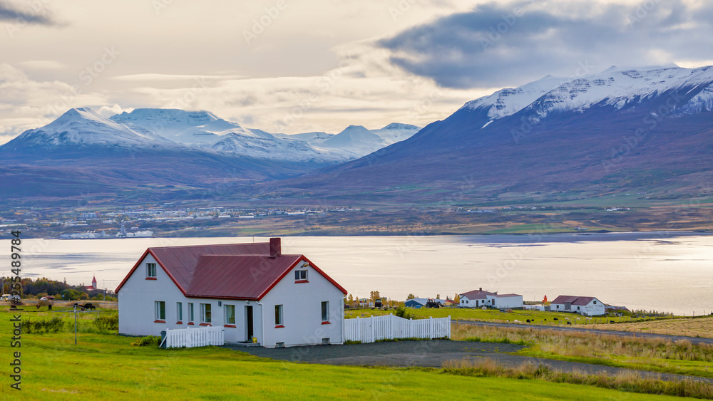 Beautiful rural view traditional house and farm field at small village in Svalbardseyri near Akureyri, Iceland