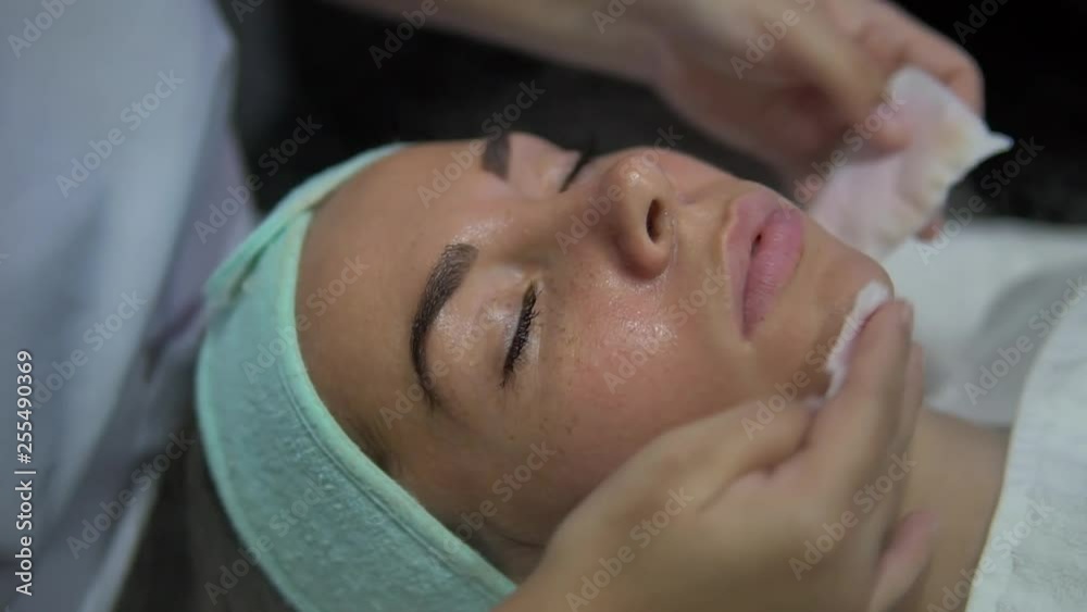 close up slow motion of relaxed young client in spa salon, having face massage close up slow motion of relaxed young client in spa salon, having face massage