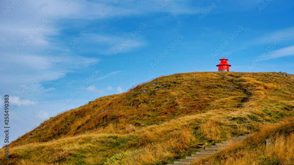 Little red lighthouse on the hill at  Sykkisholmur, Iceland