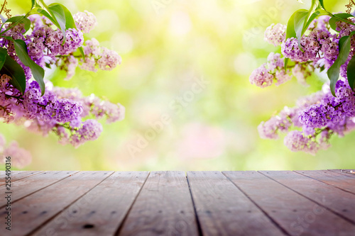 Lilac flowers in the garden over wooden deck background