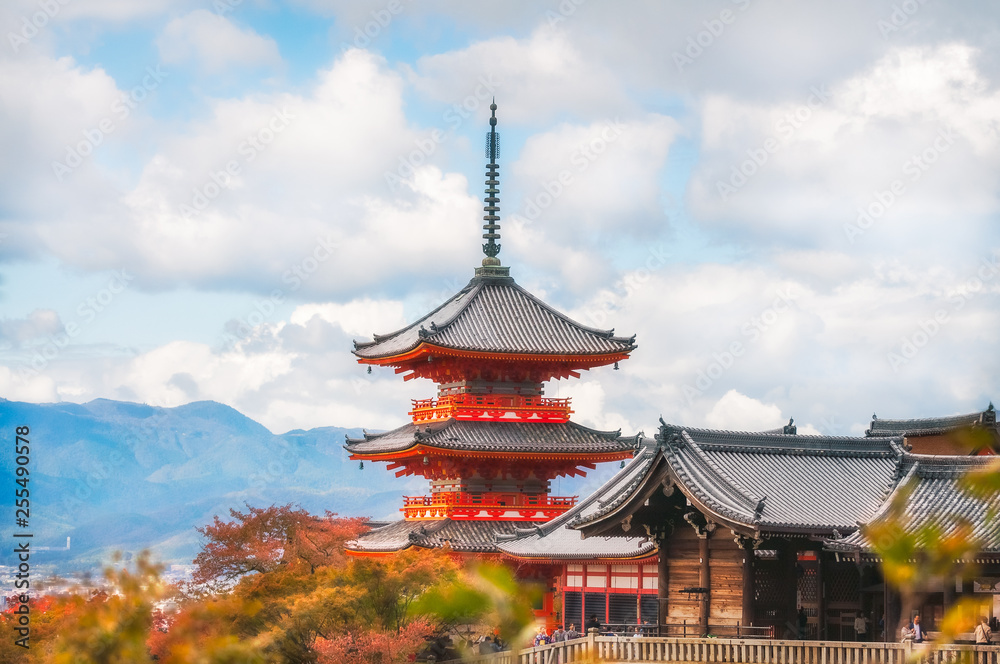View of Kiyomizu-dera main temple buildings filtered from autumn leaves in Kyoto, Japan.