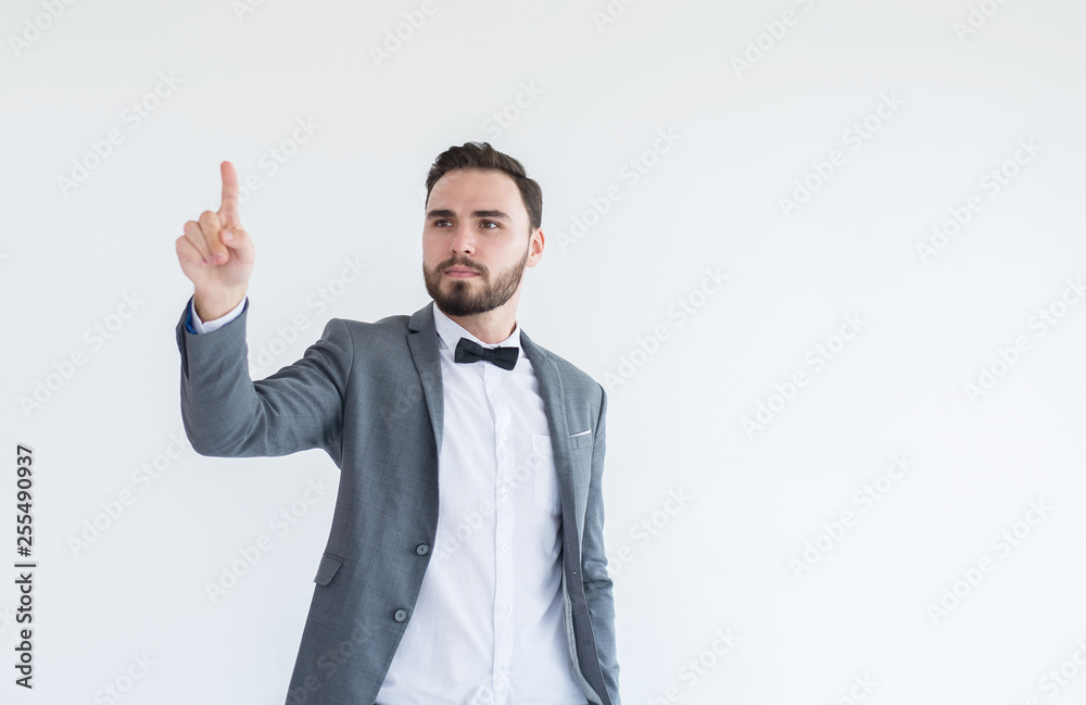 Man in formal suit standing hand touching virtual screen on white background with copy space for text Man in formal suit standing hand touching virtual screen on white background with copy space for text