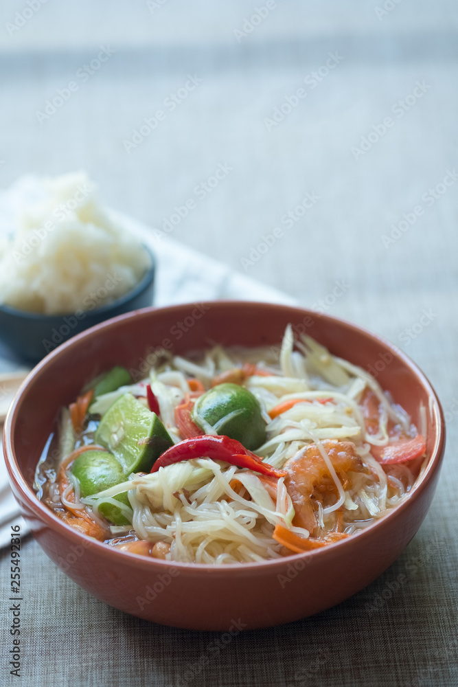 Somtum or papaya salad with red hot chili and Thai herb sauce Somtum or papaya salad with red hot chili and Thai herb sauce