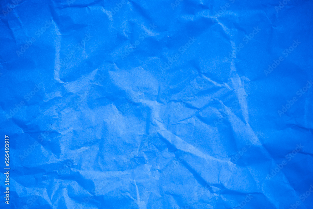 Obraz premium Crumpled blue paper background.