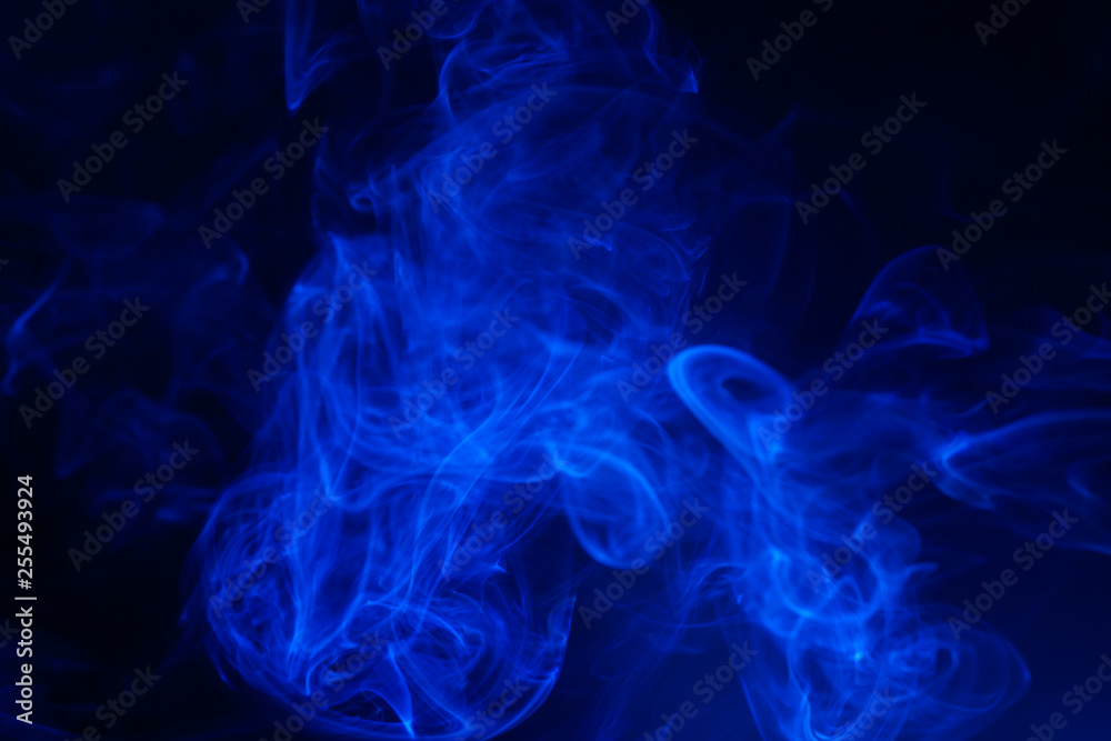 Blue smoke on black background.