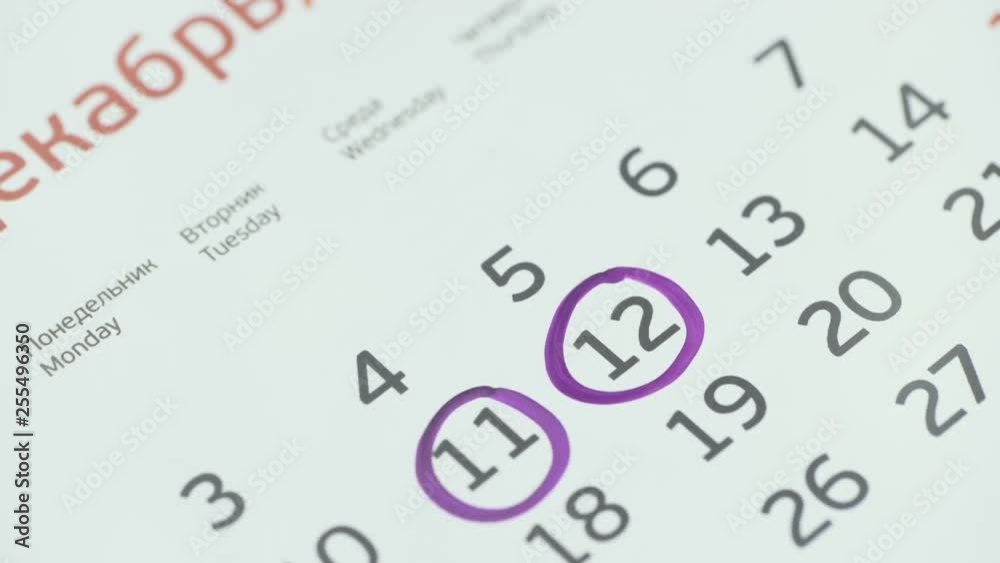 Woman hand circle day on paper calendar. 12st day of the month Woman hand circle day on paper calendar. 12st day of the month