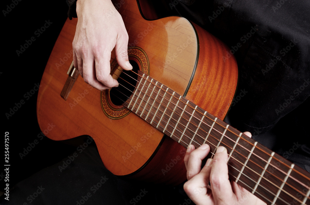 Fototapeta premium Guitarist plays the guitar. Close-up.