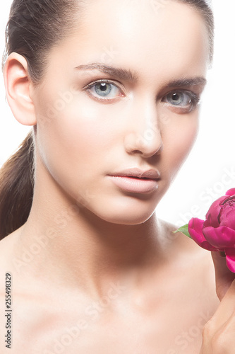 Beauty girl face with summer flower. Pink peony near woman face