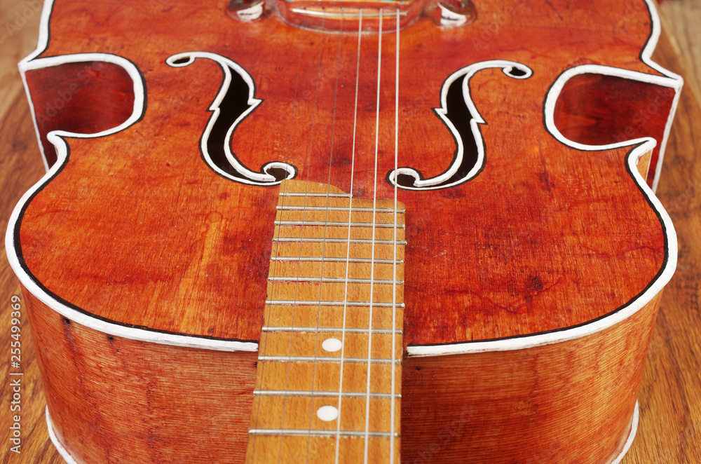 Obraz premium Vintage acoustic guitar on a textured background.